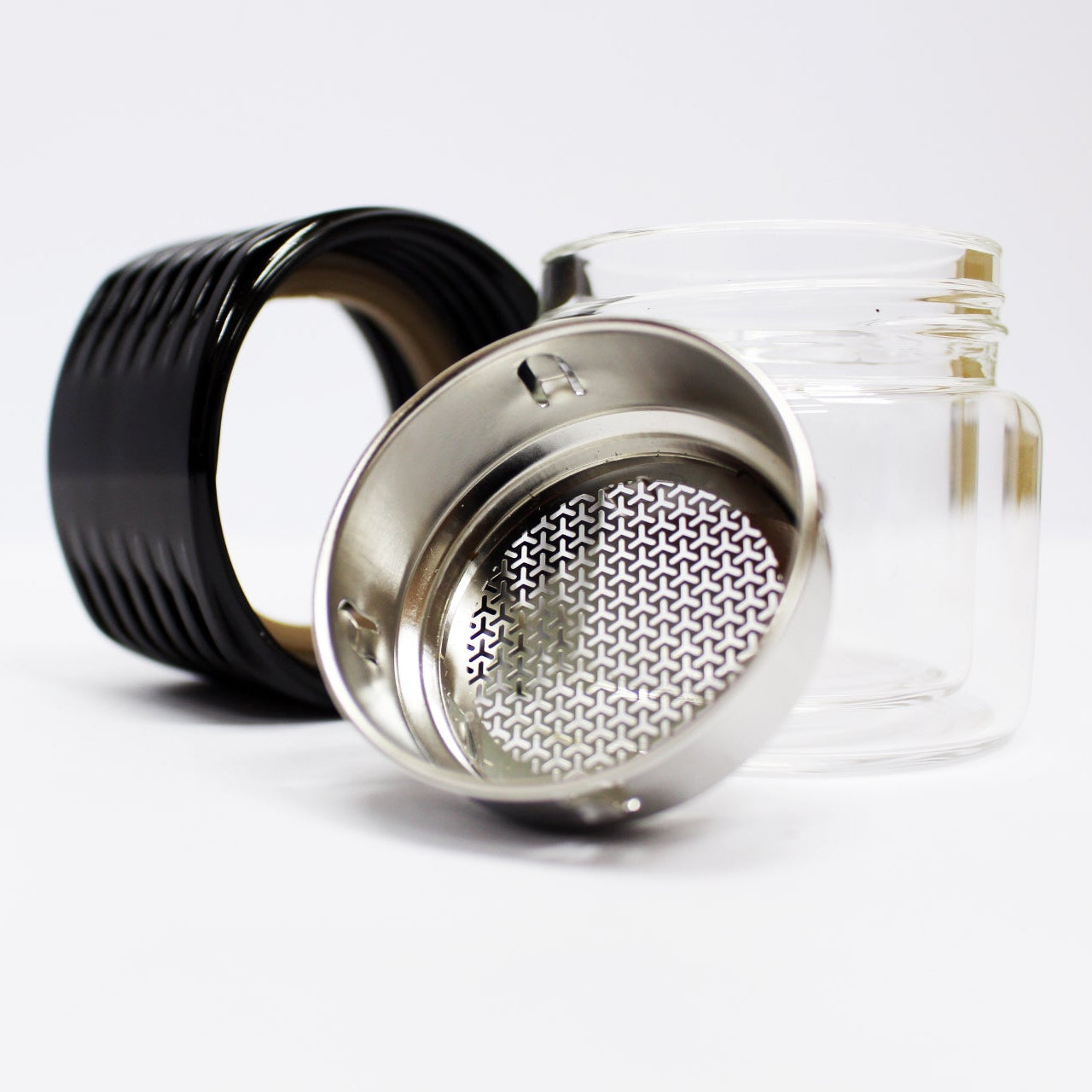 Tea infuser with black handle and metal mesh on a white background